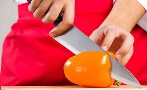 Food safety and hygiene Image of a knife cutting a pepper.